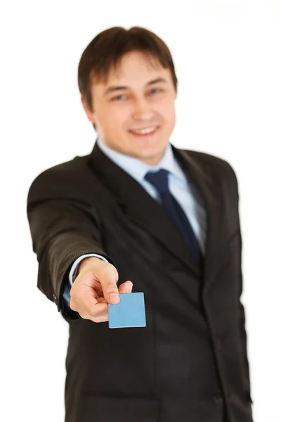 Улыбающийся молодой бизнесмен дает кредитку — стоковое фото