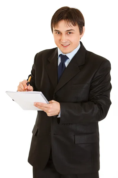 Sorrindo homem de negócios moderno fazendo anotações no caderno — Fotografia de Stock