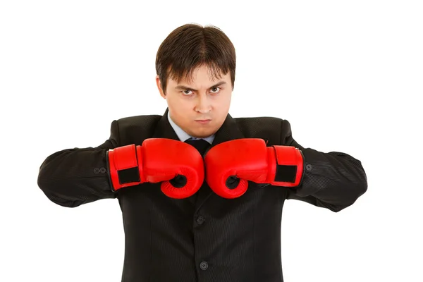 Angry young businessman with boxing gloves — Stock Photo, Image