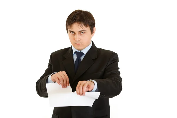 Displeased modern businessman tearing document — Stock Photo, Image