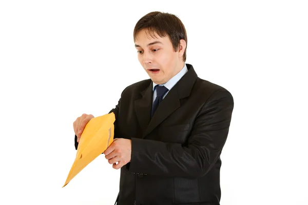 Shocked young businessman checking parcel — Stock Photo, Image