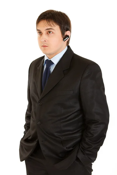 Serious modern businessman with handsfree — Stock Photo, Image