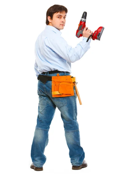 Full length portrait of construction worker with drill look back — Stock Photo, Image