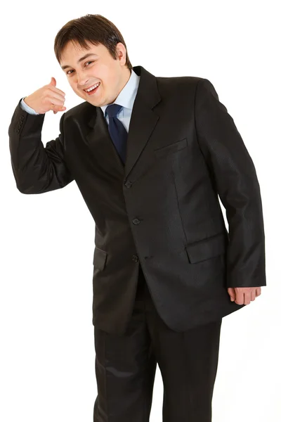 Sonriente joven hombre de negocios mostrando contacto conmigo gesto — Foto de Stock
