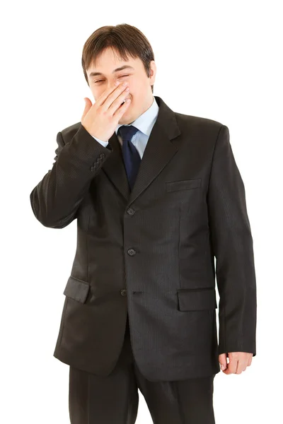 Homem de negócios rindo fechando a boca à mão — Fotografia de Stock