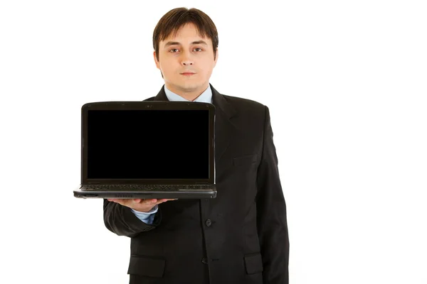 年轻的商人持有与空白屏幕的笔记本电脑 — 图库照片