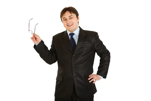 Elegant young businessman holding eyeglasses in hand — Stock Photo, Image