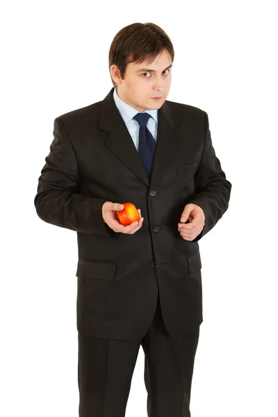 stock image Thoughtful modern businessman holding apple in hand