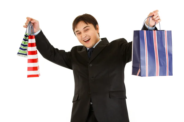Zufriedener Geschäftsmann hält Einkaufstüten in den Händen — Stockfoto