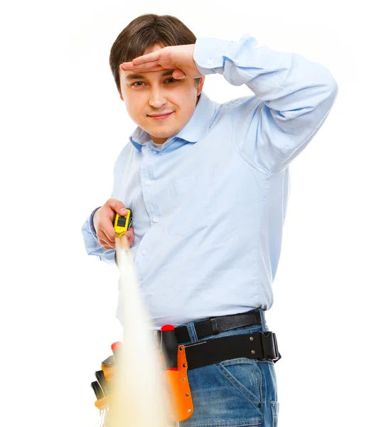 Construction worker looking into the distance on ruler — Stock Photo, Image