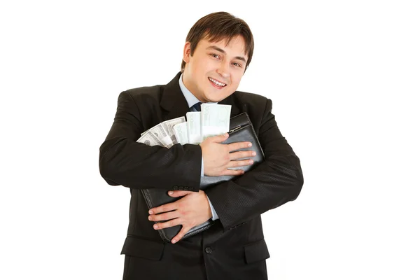 Успешный бизнесмен обнимает портфель с деньгами в руках — стоковое фото