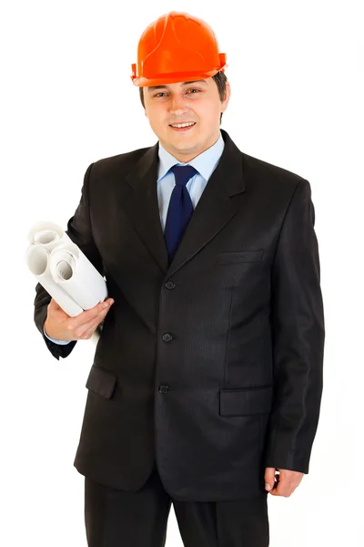 Empresário sorridente no capacete segurando planos de construção na mão — Fotografia de Stock