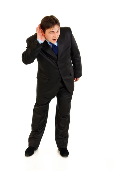 Full length portrait of stressful businessman holding hand at ear and liste — Stock Photo, Image