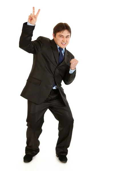 Feliz hombre de negocios moderno mostrando gesto de victoria —  Fotos de Stock