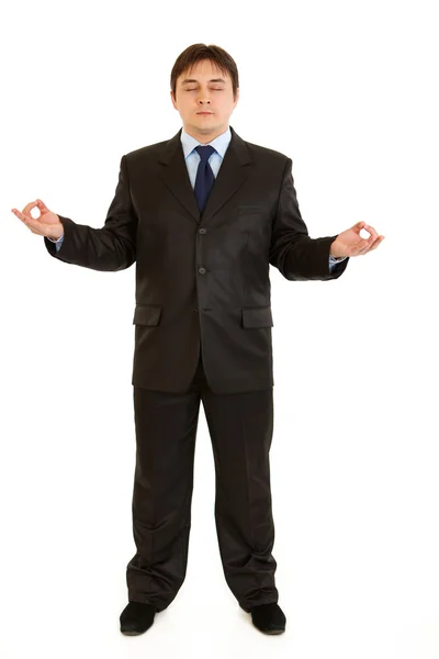 Meditando hombre de negocios moderno aislado sobre fondo blanco —  Fotos de Stock