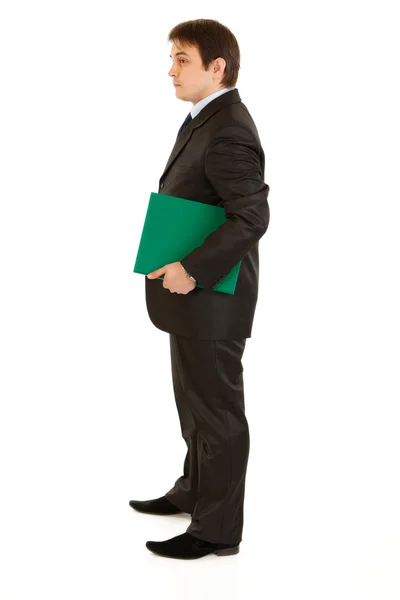 Full length portrait of serious modern businessman holding folder in hand — Stock Photo, Image