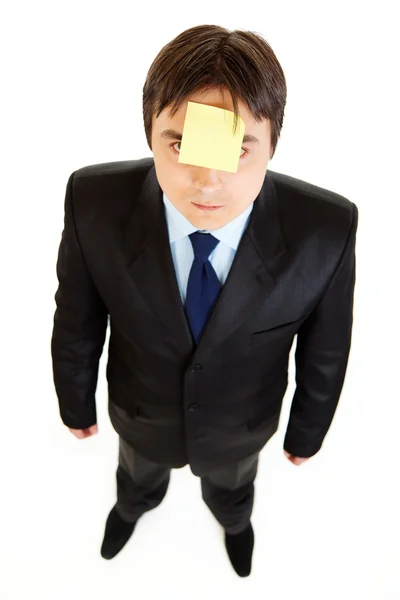 Young businessman with blank sticky note on his forehead — Stock Photo, Image