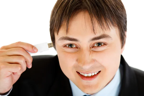 stock image Smiling businessman plugging flash drive into head. Concept - future techno