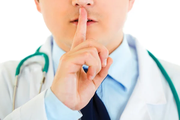 stock image Medical doctor with finger at mouth. Shh gesture