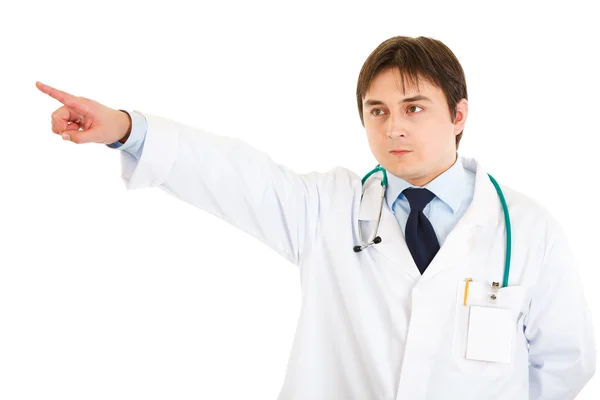 Confident medical doctor pointing finger at something — Stock Photo, Image