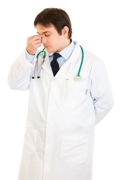 Stressed medical doctor holding fingers at noseband — Stock Photo, Image