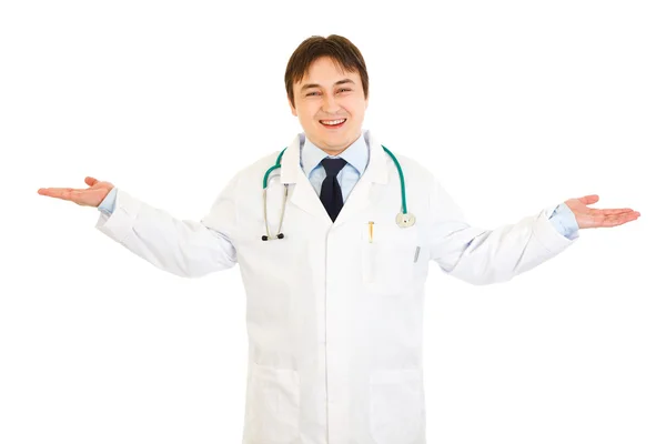 Pleased medical doctor presenting something on empty hands — Stock Photo, Image
