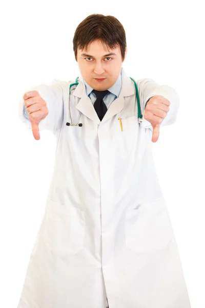 Serious young medical doctor pointing fingers down — Stock Photo, Image