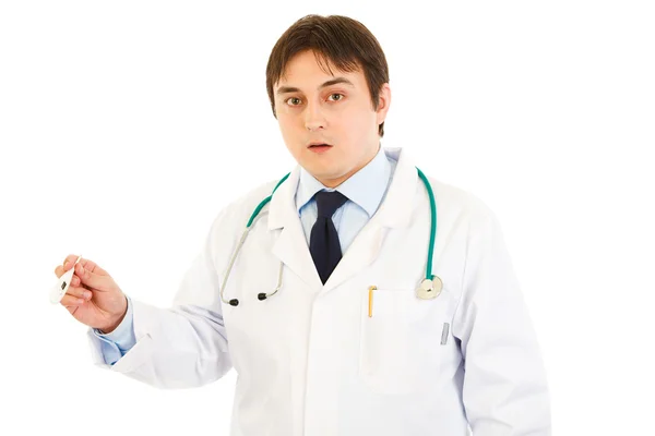 Shocked doctor holding medical thermometer in hand — Stock Photo, Image