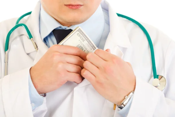 Medical doctor putting money in pocket. Close-up. — Stock Photo, Image