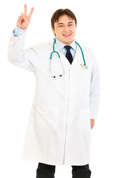 Happy medical doctor showing victory gesture — Stock Photo, Image