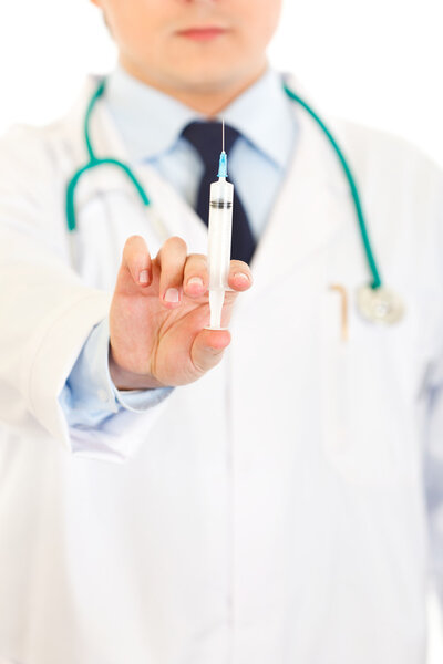 Doctor with medical syringe in hands. Close-up.