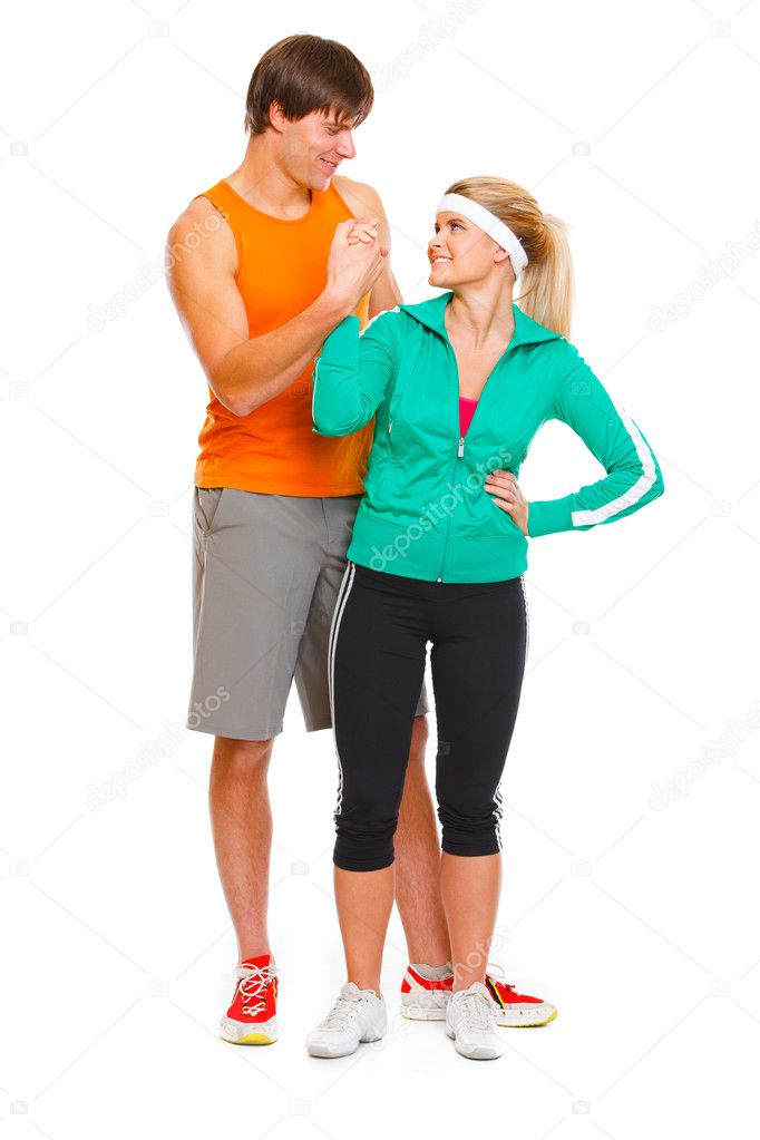 Happy male athlete and fitness young woman handshaking isolated