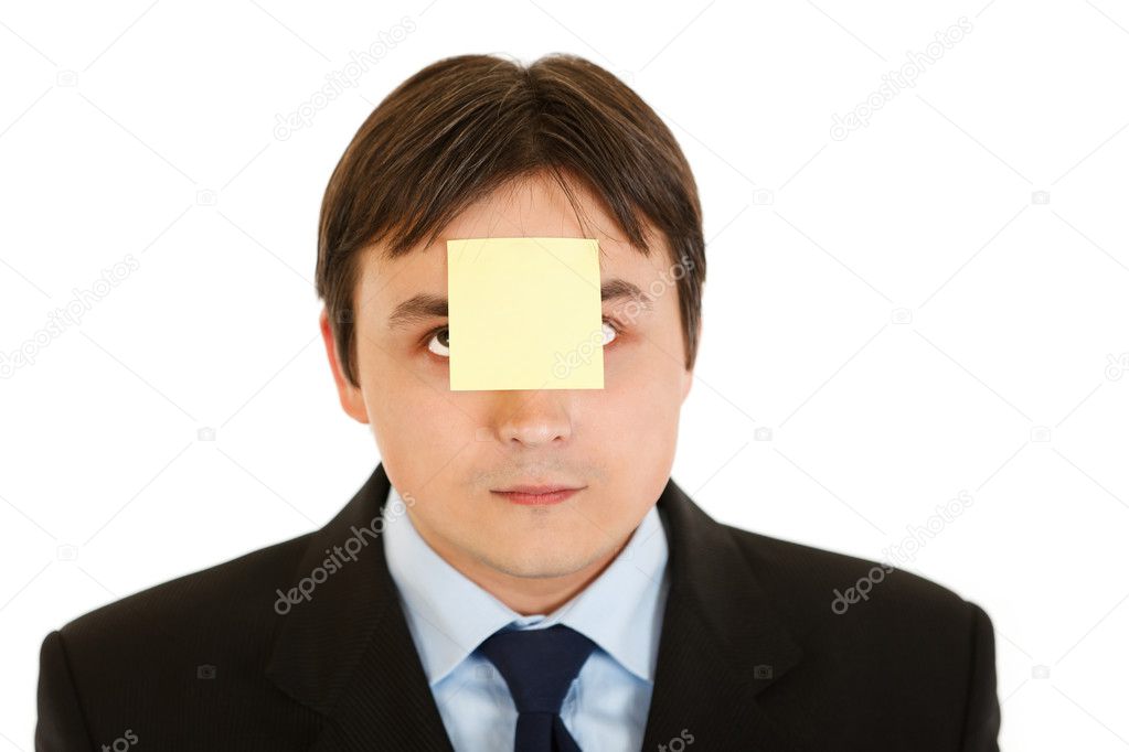 Young businessman with blank adhesive note over his mouth