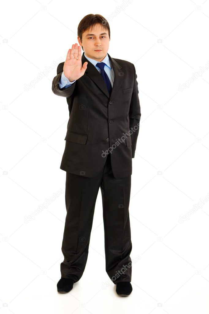 Full length portrait of confident modern businessman showing stop gesture