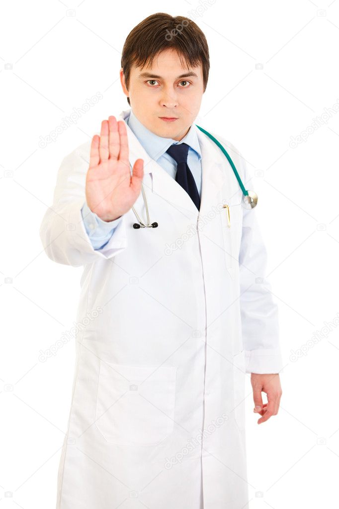 Authoritative medical doctor showing stop gesture