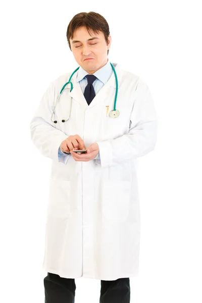 Very pleased medical doctor counting on calculator — Stock Photo, Image
