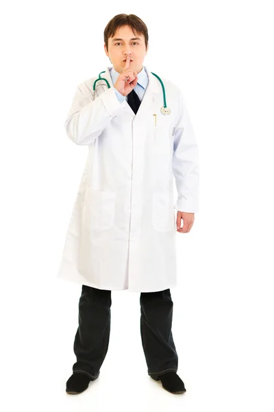 Serious medical doctor with finger at mouth. Shh gesture — Stock Photo, Image