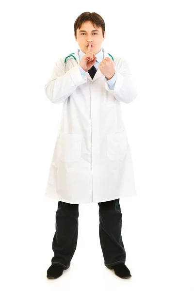 Full length portrait of angry medical doctor with finger at mouth and th — Stock Photo, Image