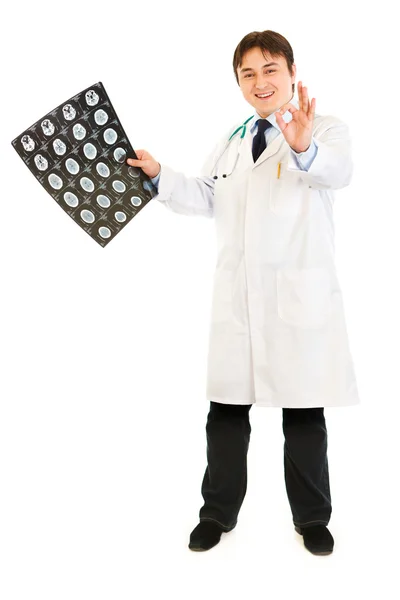Smiling doctor holding tomography and showing ok gesture — Stock Photo, Image