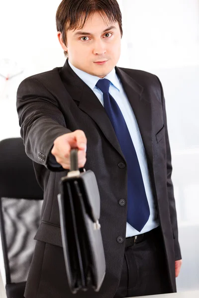 Hombre de negocios autorizado parado en el escritorio de la oficina y dando maletín. Clo. — Foto de Stock