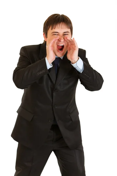 Злой современный бизнесмен кричит через руки в форме мегафона — стоковое фото