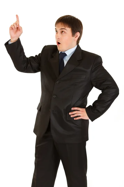 Surprised young businessman with rised finger. Idea gesture. — Stock Photo, Image