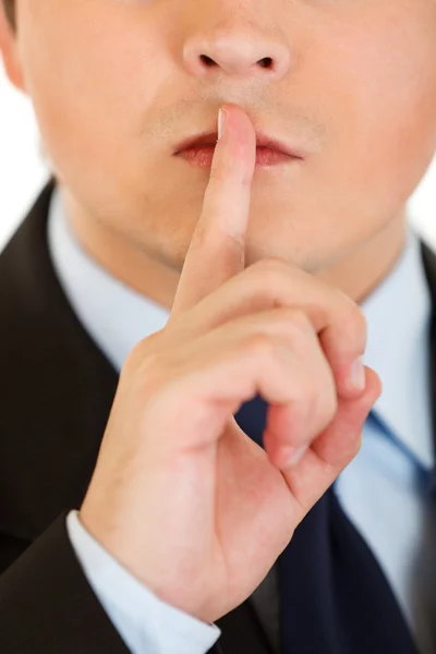 Empresario con el dedo en la boca. Shh gesto — Foto de Stock