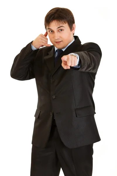 Smiling young businessman showing contact me gesture — Stock Photo, Image