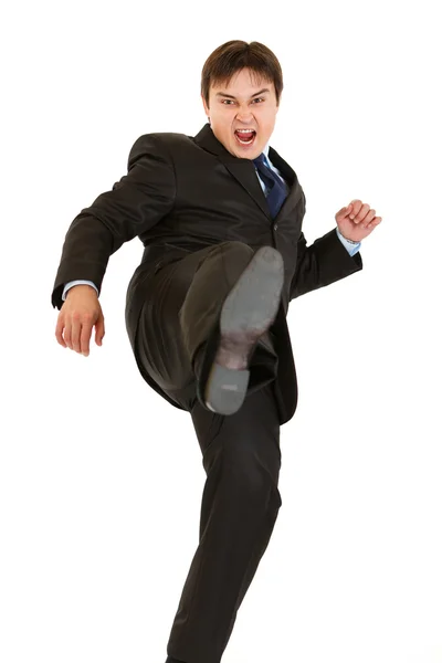 Very angry young businessman hard kicking — Stock Photo, Image