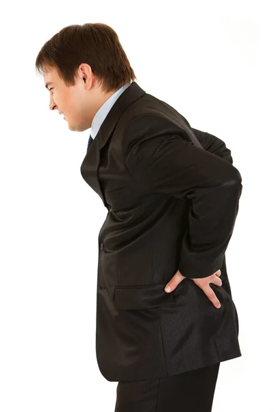 Joven hombre de negocios sosteniendo su mano a su espalda dolorida — Foto de Stock