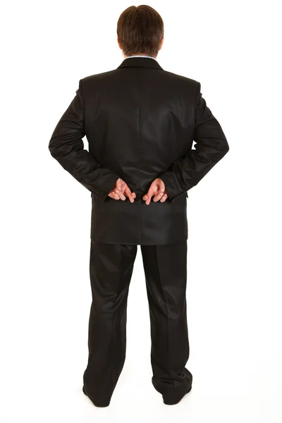Businessman holding crossed fingers behind back — Stock Photo, Image