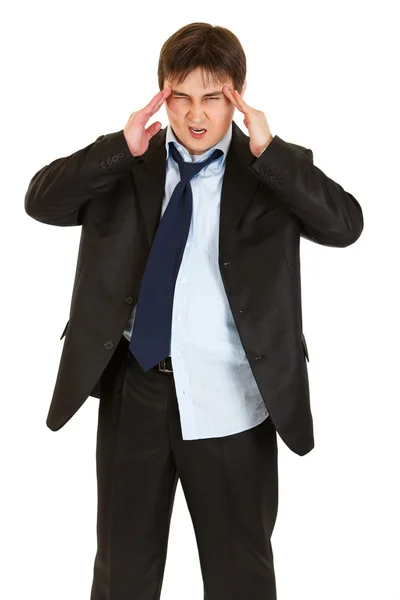 Young businessman with headache holding hands at head — Stock Photo, Image