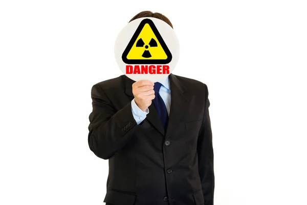 Evidentemente pericolo di radiazioni! Uomo d'affari che tiene il cartello delle radiazioni di fronte — Foto Stock