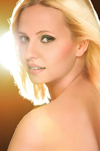Portrait of pretty blond hair woman in flash lights. Retouched — Stock Photo, Image